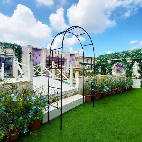 Powder Coated Iron Garden Pergola Arbor Built For Climbing Plants Pro Grade Trellis Archway All Weather Outdoor Backyard Pathway Decor For Roses And Grapevines 7 Ft High 4 Ft Wide Durable, standing in a lush garden setting.