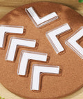 Eight Pack Silicone Corner Protectors for Baby Proofing and Home Safety Edge Guards on cork surface