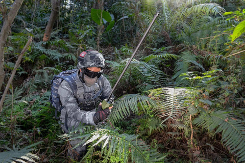 Person using Dual Band Ham Radio Antenna Foldable 42.5 Inch 136-520MHz CS Tactical SMA Female Omni Directional 3.5dBi in forest