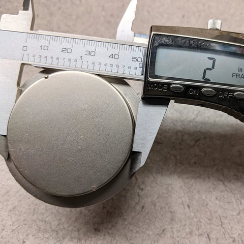 Two Inch Satin Nickel Closet Door Finger Pulls Set of 2 with Stamped Steel Construction and Satin Nickel Plated Finish shown with caliper