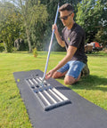 Person using 38 Inch Wide Leveling Lawn Rake with Stainless Steel Head and 72 Inch Aluminum Handle on grass