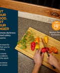 Person chopping peppers on a cutting board in a kitchen with Under Cabinet LED Light Kit For Kitchen With Motion Sensor 3 Light Strips