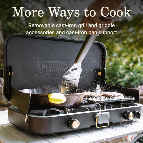 3 In 1 Propane Camping Stove With Cast Iron Grill And Griddle showing a spatula cooking outdoors