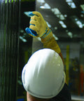 Worker using Heavy Duty Latex Palm Coated Safety Gloves With Kevlar Liner For Cut Resistance A3, handling industrial materials.