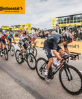 Cyclists racing during a competitive bike event with Continental branding in the background.