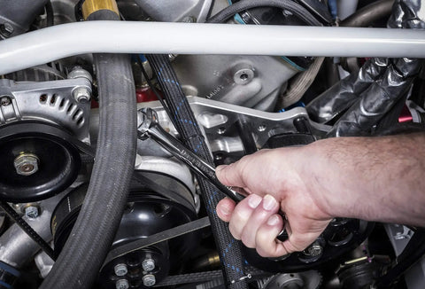 Mechanic using 15 Piece Long Pattern SAE Wrench Set With Tool Roll, 12 Point Off Corner Load For Better Grip in car repair