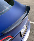Real Molded Carbon Fiber Matte Dry Look Spoiler For Tesla Model 3 viewed from above, showcasing its sleek aerodynamic design.