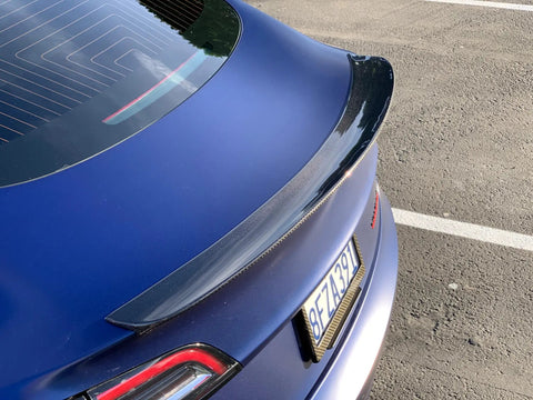 Real Molded Carbon Fiber Matte Dry Look Spoiler For Tesla Model 3 viewed from above, showcasing its sleek aerodynamic design.