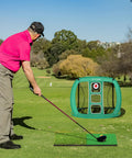 Golfer using Grab-And-Go Portable Golf Chipping Net Set With Two Hitting Mats And Fifteen Training Balls for practice