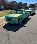 Rich Jade Green Basecoat Paint Gallon Drop In Ready To Spray vehicle parked on street with shiny finish and sleek design.
