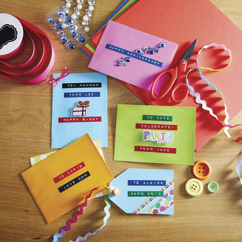 Colorful envelopes with labels made using Embossing Label Maker Kit With 3 Tapes Ergonomic Handheld Labeler For Home DIY.