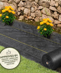 Pro 5 Weed Barrier Fabric 5 Oz Heavy Duty Ground Cover Mat 3 x 250 ft installed with flowers on landscape