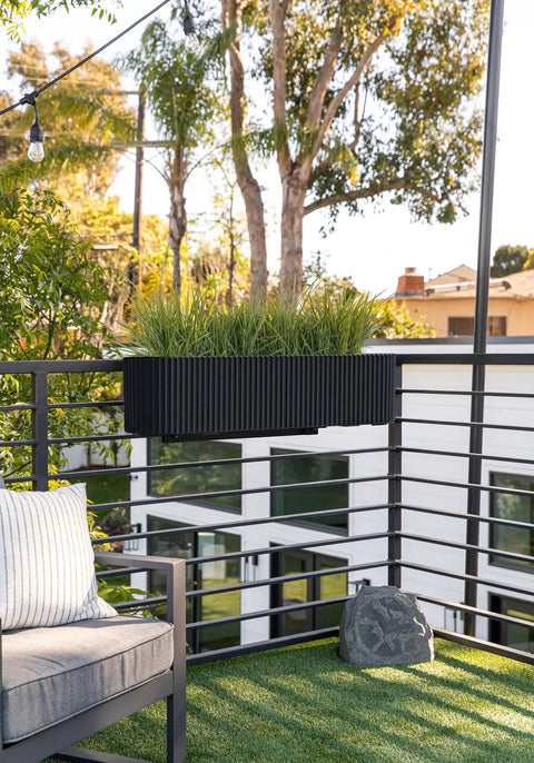 Badass Weatherproof Railing Planter Box With Secure Mounting Bracket Hella Durable Plastic Stone Composite on balcony with grass.