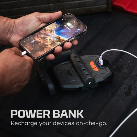 Omni 3K Rechargeable Work Light With 3000 Lumens charging a phone via USB-C cable, showing power bank feature.