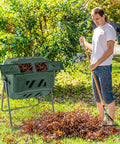 Man using Outdoor 42 Gallon Dual Chamber Compost Tumbling Bin With 360 Degree Rotating Barrel Heavy Duty Metal Frame BPA Free in garden