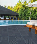 9 Pack 12 Inch Square Interlocking Floor Tiles With 0.4 Inch Thick Dark Gray Non Slip Mats And Drainage Grooves For Pool Deck Shower Bathroom Garage Boat And Other Wet Areas Highly Grippy And DIY Friendly by a poolside view