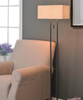 Emilio Floor Lamp With Bronze Finish In Prairie Style Box Frame And Tan Rectangular Drum Shade next to beige armchair