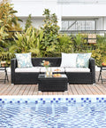 Outdoor Folding Round Patio End Table With Silk Tempered Glass Top And Lightweight Steel Frame beside a poolside sofa.
