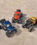 Top view of three Atlas S One Tenth RC Crawler Four By Four Beast Off Road Rock Trucks on gravel for adults
