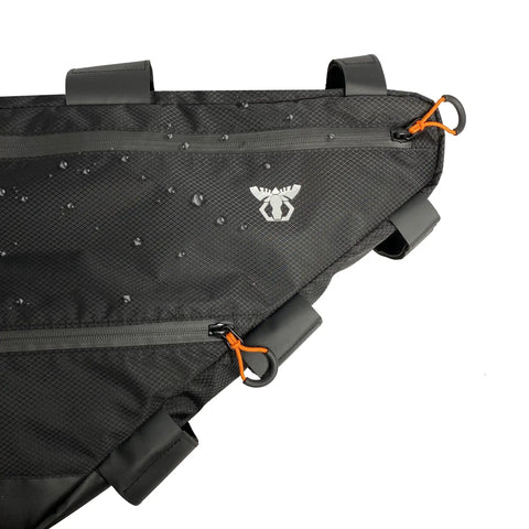 Full Frame Bike Bag For Bikepacking And Commuting Large 14L Three Size Options To Fit Most Touring And Fat Bike Frames Ride Ready Quick Access Gear Pocket Durable Water Resistant Construction, showing close-up of zipper details and water droplets on the fabric.