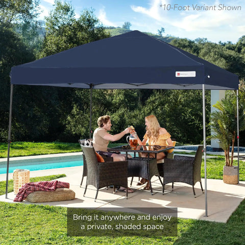 10-foot navy blue pop up canopy tent set up in a backyard by a pool, with two people seated underneath during a sunny day.