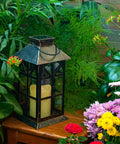 Solar Lantern Outdoor Waterproof Hanging Light For Garden Patio And Porch With Flickering LED Flames in a garden setting