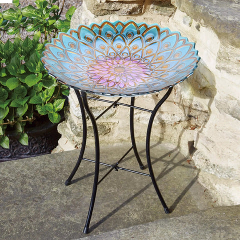 Handpainted Mosaic Flower Fusion Glass Pedestal Bird Bath For Outdoor Patio Garden Backyard Deck Decor, 21 Inch Height In Blue And Purple, Multi Functional Waterer Or Bird Feeder With Foldable Stand on stone patio.