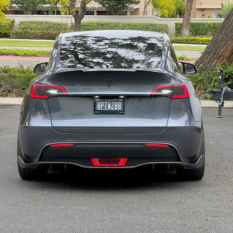 Dope Tesla Model Y Led Brake And Turn Signal Kit With Smoke Tint Lens installed on a gray Tesla rear view.