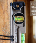 Magnetic Box Beam Level For Framing And Layout 10 Inch Torpedo With Tourniquet Bungee System attached to wooden beam, close-up.