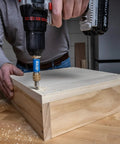 Your New Shop Floor Favorite Features A Heavy Duty Two Sided Drill Bit And Driver in use, drilling pilot holes in wood.
