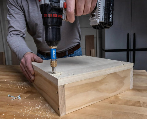 Your New Shop Floor Favorite Features A Heavy Duty Two Sided Drill Bit And Driver in use, drilling pilot holes in wood.