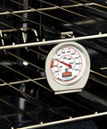 Stainless Steel Monitoring Thermometer For Oven, Grill And Smoker 60 To 580 F Range Food Safe Easy Read Dial Ideal For Restaurant Or Home Cooking Everyday, placed on oven rack.