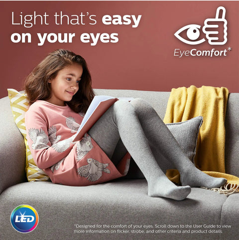 Girl reading on couch under Non Dimmable G25 LED Light Bulbs With Frosted Glass Flicker Free And EyeComfort Technology lighting.