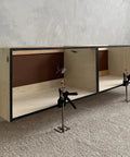 Two Viking Arm handheld lifting clamps mounted under a two-compartment plywood cabinet with metal frame.