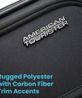 Close-up of lightweight spinner carry-on luggage with carbon fiber trim and rugged polyester material in black.