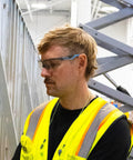 Man wearing Top Shelf Safety Glasses Featuring Anti Scratch Impact Resistant Wraparound Design With Ansi Z87 Plus High Impact Rating.