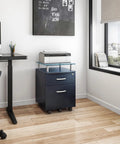 Heavy Duty Two Drawer Rolling File Cabinet With Secure Lock And Sleek Glass Top Fits Under Desk Smooth Chrome Glide Wheels Graphite Finish in a home office setting.