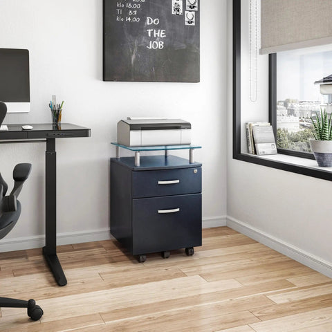 Heavy Duty Two Drawer Rolling File Cabinet With Secure Lock And Sleek Glass Top Fits Under Desk Smooth Chrome Glide Wheels Graphite Finish in a home office setting.