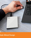 5TB My Passport Ultra For Mac Portable External Hard Drive With USB C And USB 3.1 connected to laptop, sleek metal design.