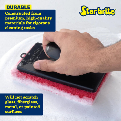 Hand using All-Purpose Scrubber Pad With Ergonomic Handle In Red on surface, showcasing fine texture for cleaning boats and outdoor use.