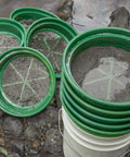 9-Piece Patented Stackable Gold Prospecting Sifting Pan Set With Stainless Steel Mesh on a bucket by stream