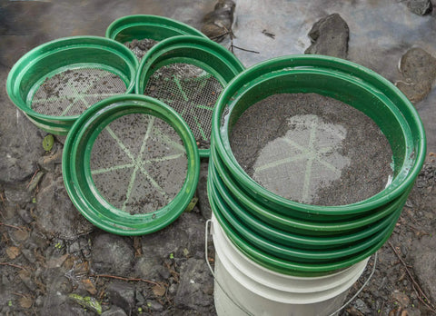 9-Piece Patented Stackable Gold Prospecting Sifting Pan Set With Stainless Steel Mesh on a bucket by stream
