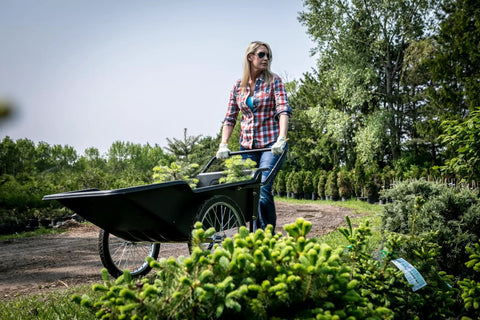 Woman using Beefy Heavy Duty Utility Cart With 10 Cubic Feet Tub And 400 Pound Load Capacity With Flat Free Wheels in garden