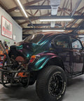 Fresh Shop Grade Superflake Colorshift Basecoat Paint Gallon Ready To Spray With Slow Reducer Binder For Custom Rigs Delivering Dope Shiftin Shades on a custom painted Volkswagen in a garage.