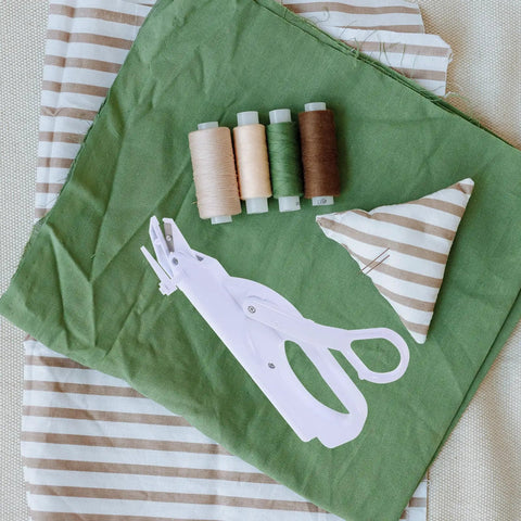 Cordless Electric Scissors For Fabric Cutting Handheld Sewing Tool With Safety Lock And Protective Cover Rechargeable Battery Operated Machine For Cloth Leather Paper Easy Use Durable Design on green fabric with thread spools.