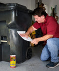 Man applying thick rubberized waterproof tape that seals leaks, patches cracks, and repairs like a pro, even underwater, to a trash bin.