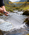 Person holding a Square BBQ Fish Basket For Grilling Great For Camping Stainless Steel Rust Resistant Easy To Clean Stable Design