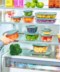 A hand placing a container from the 24 Piece Glass Food Storage Set With Airtight Lids, Leakproof BPA Free Meal Prep Containers in a fridge.