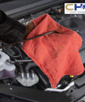 Hand using Red Cotton Shop Towels 100 Percent Cotton Multipurpose Mechanic Garage Rags Highly Absorbent Auto Detailing Cloths 12x14 Inches Pack Of 25 Ideal For Oil Wipes Messes And General Cleanup In The Shop on car engine