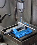 5 Inch Unigrip Drill Press Vise with 4-3/8 Inch Jaw Opening on drill press, gripping metal rod securely for precise work